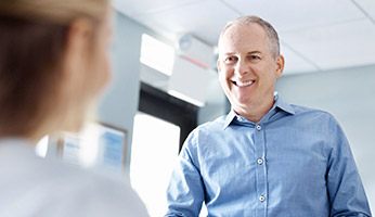 Smiling man at reception desk